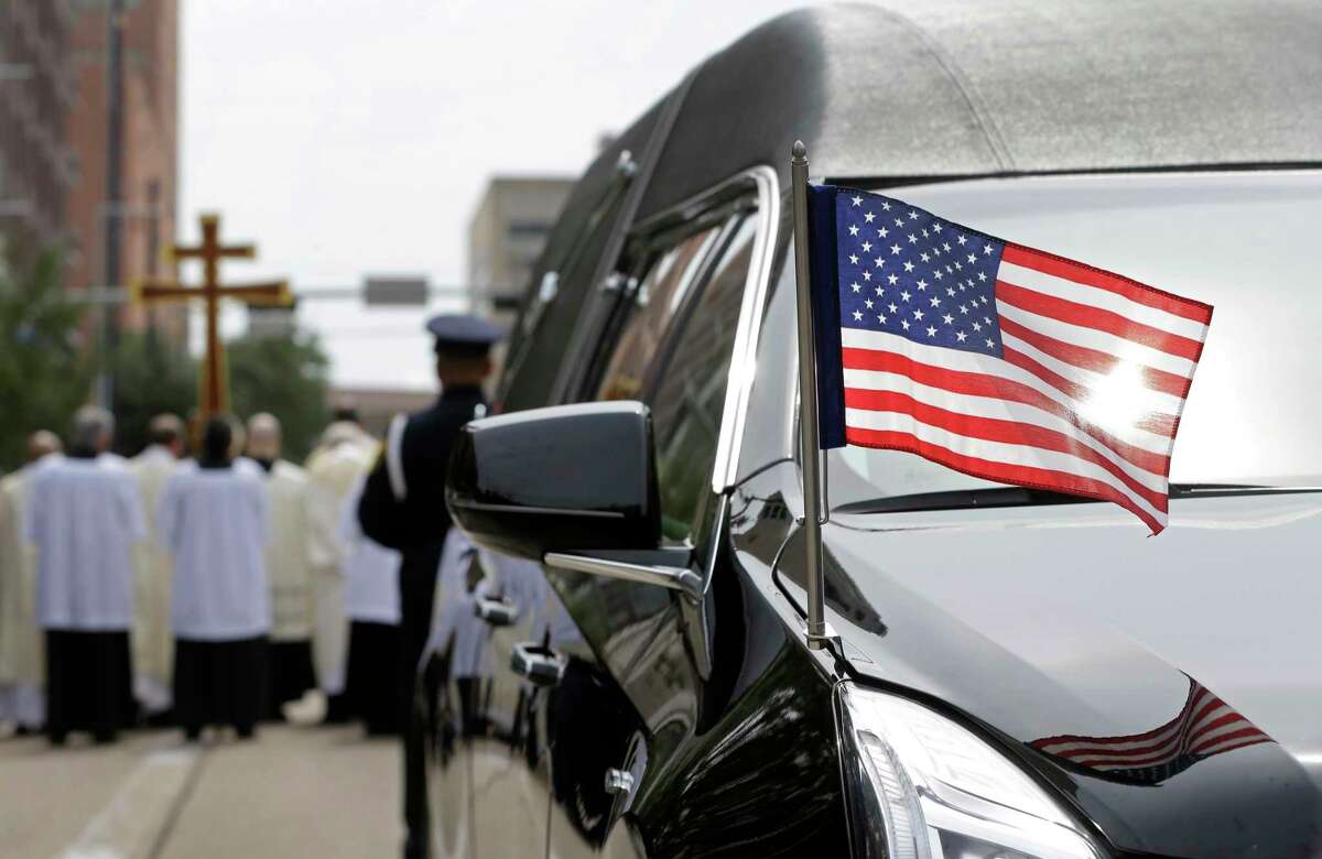 A flag is shown on the hearse for Houston Police Sergeant Steve Perez, 60, outside the Co-Cathedral of the Sacred Heart, 1111 St. Joseph Parkway, Wednesday, Sept. 13, 2017, in Houston. Sgt. Perez died in the line of duty while reporting for work during Hurricane Harvey.