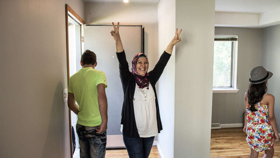 A Syrian refugee reacts after seeing her family's new home in Bloomfield Hills, MI Photo: Andrew Renneisen/Getty Images