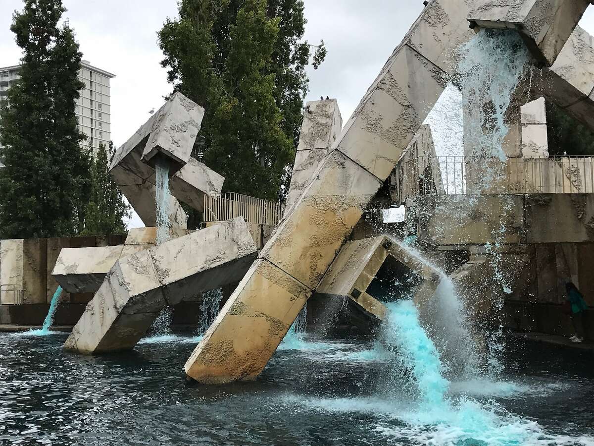 Blue water is flowing out of the Vaillancourt Fountain, which was installed along The Embarcadero in 1971.
