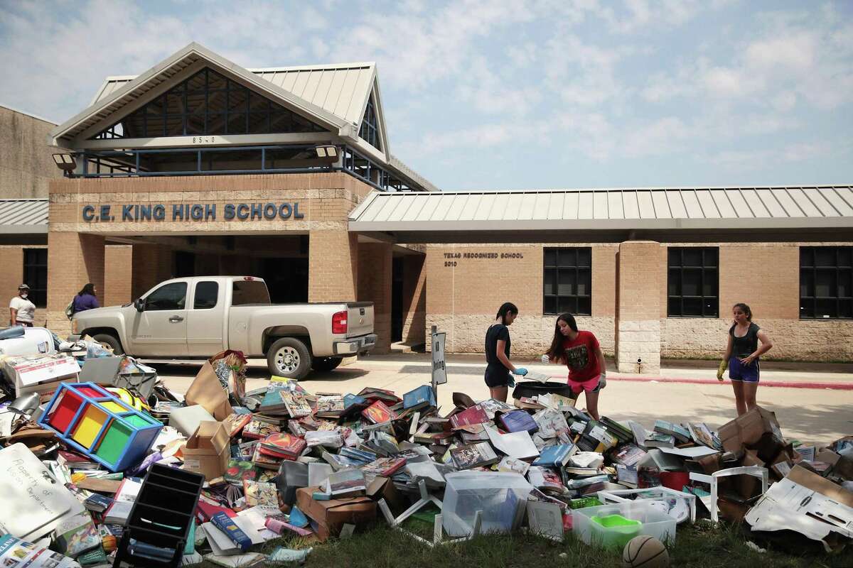HOUSTON, TX - SEPTEMBER 01: Volunteers and students from C.E. King High School help to clean up the school after torrential rains caused widespread flooding in the area during Hurricane and Tropical Storm Harvey on September 1, 2017 in Houston, Texas. Harvey, which made landfall north of Corpus Christi on August 25, dumped around 50 inches of rain in and around areas of Houston and Southeast Texas. (Photo by Scott Olson/Getty Images)