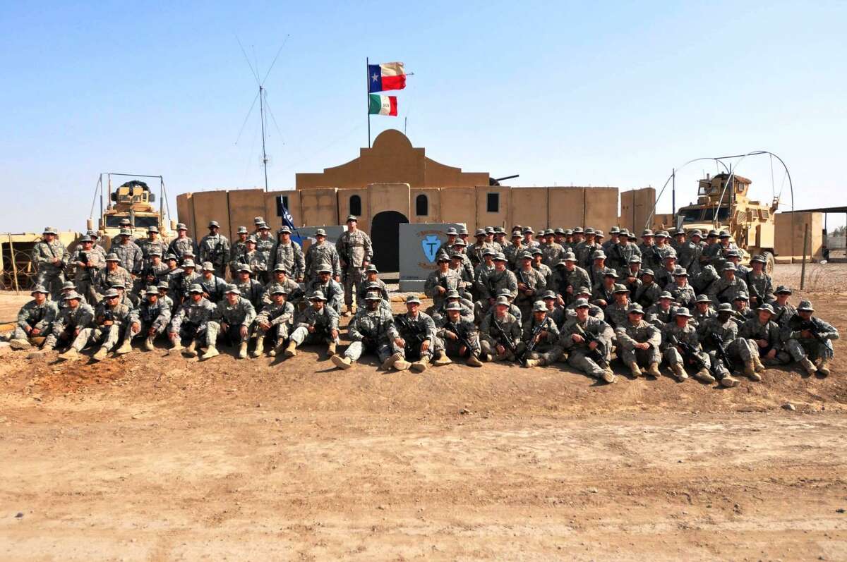 Members of Alpha Company of the 141st Infantry Regiment pose in front of an Alamo replica built in 2010 at Camp Liberty near Baghdad. The 141st traces it's lineage back to Company A, of the Texas Volunteers at the Alamo.