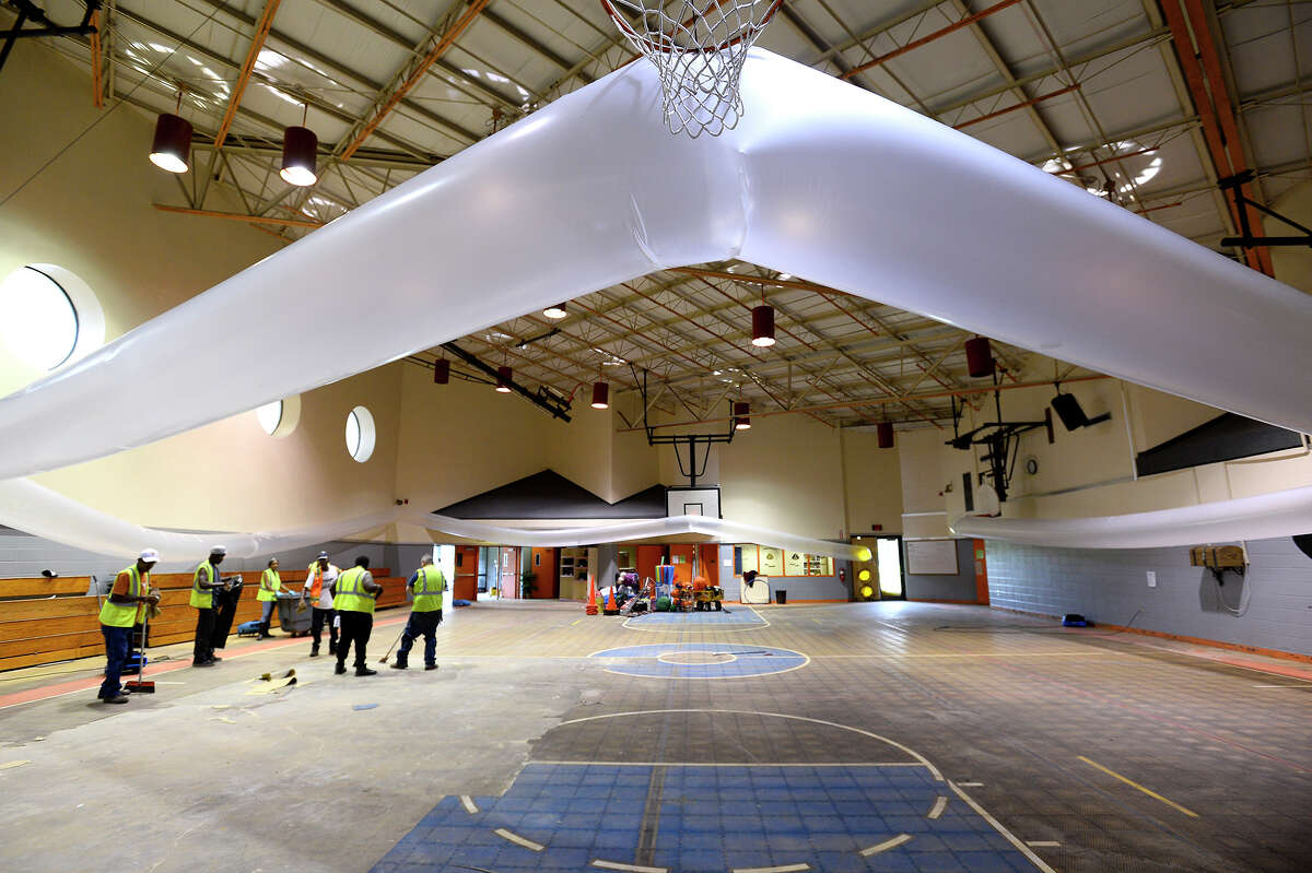 Drying equipment pumps air into the gym while workers tear out the flooring at Vidor Middle School on Thursday. The school's fifth graders will go to class in a separate wing at Vidor High School, and the sixth graders will go to the junior high. Photo taken Thursday 9/14/17 Ryan Pelham/The Enterprise