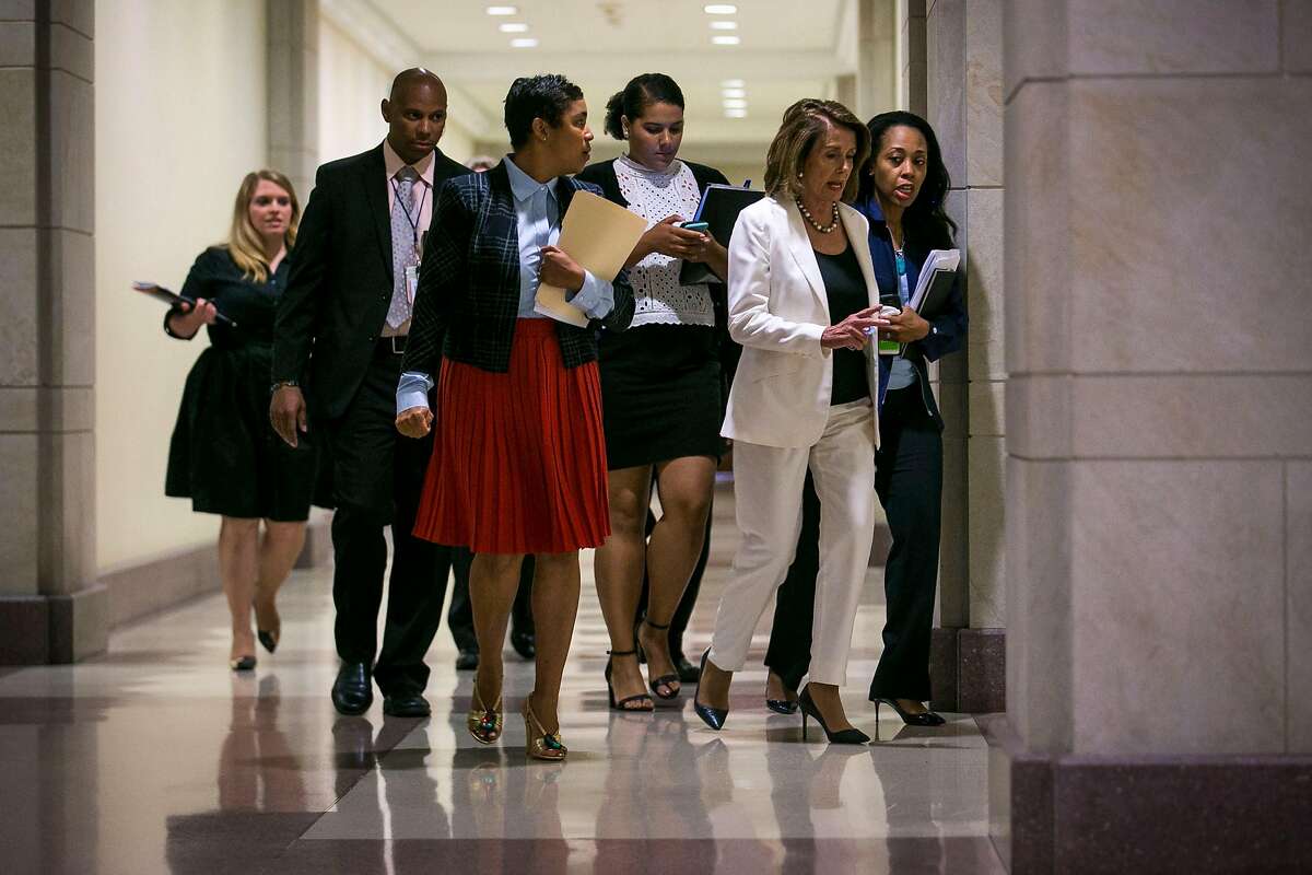 House Minority Leader Nancy Pelosi (D-Calif.) arrives with her staff to a news conference on Capitol Hill, in Washington, Sept. 14, 2017. After a dinner meeting the night before with Pelosi and Senate Minority Leader Chuck Schumer (D-N.Y.), President Donald Trump confirmed Thursday morning that he supports legislation that would protect young undocumented immigrants from deportation and would deliver a �massive� increase in border security � but not with a wall on the southern border. (Al Drago/The New York Times)