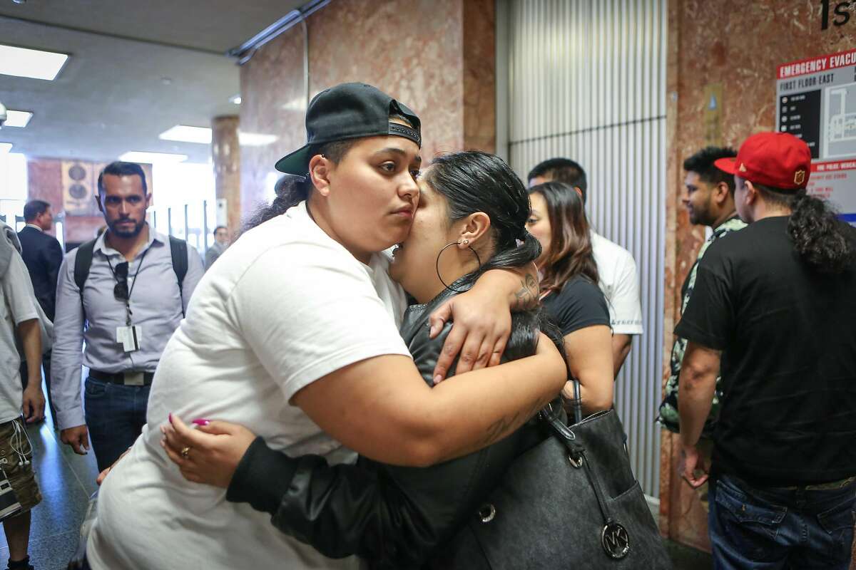 Family members and friends of Abel Enrique Esquivel embrace after the arraignment of the man accused of murdering him on Thursday, September 14, 2017 at the Hall of Justice in San Francisco, Calif.