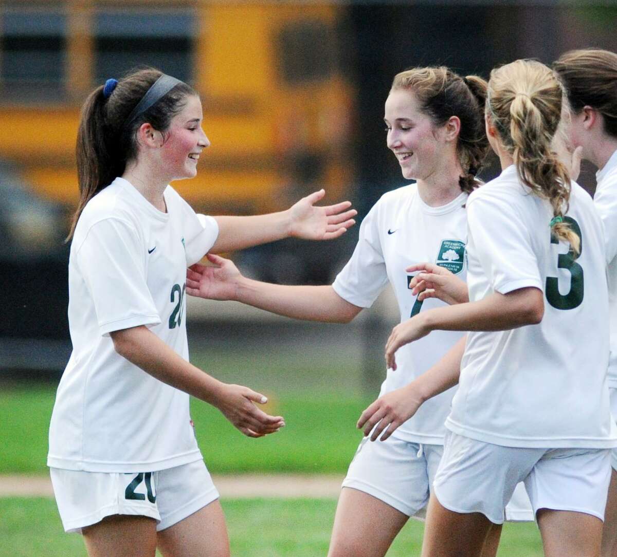 Taylor Lane, (#20), left, and Katie Goldsmith, (#3), right, congratulate their Greenwich Academy teammate Tessa Brooks, center, after Brooks scored a goal during the first half of the girls high school soccer match between King School and Greenwich Academy at King in Stamford, Conn., Thursday, Sept. 14, 2017. GA defeated King, 6-0.
