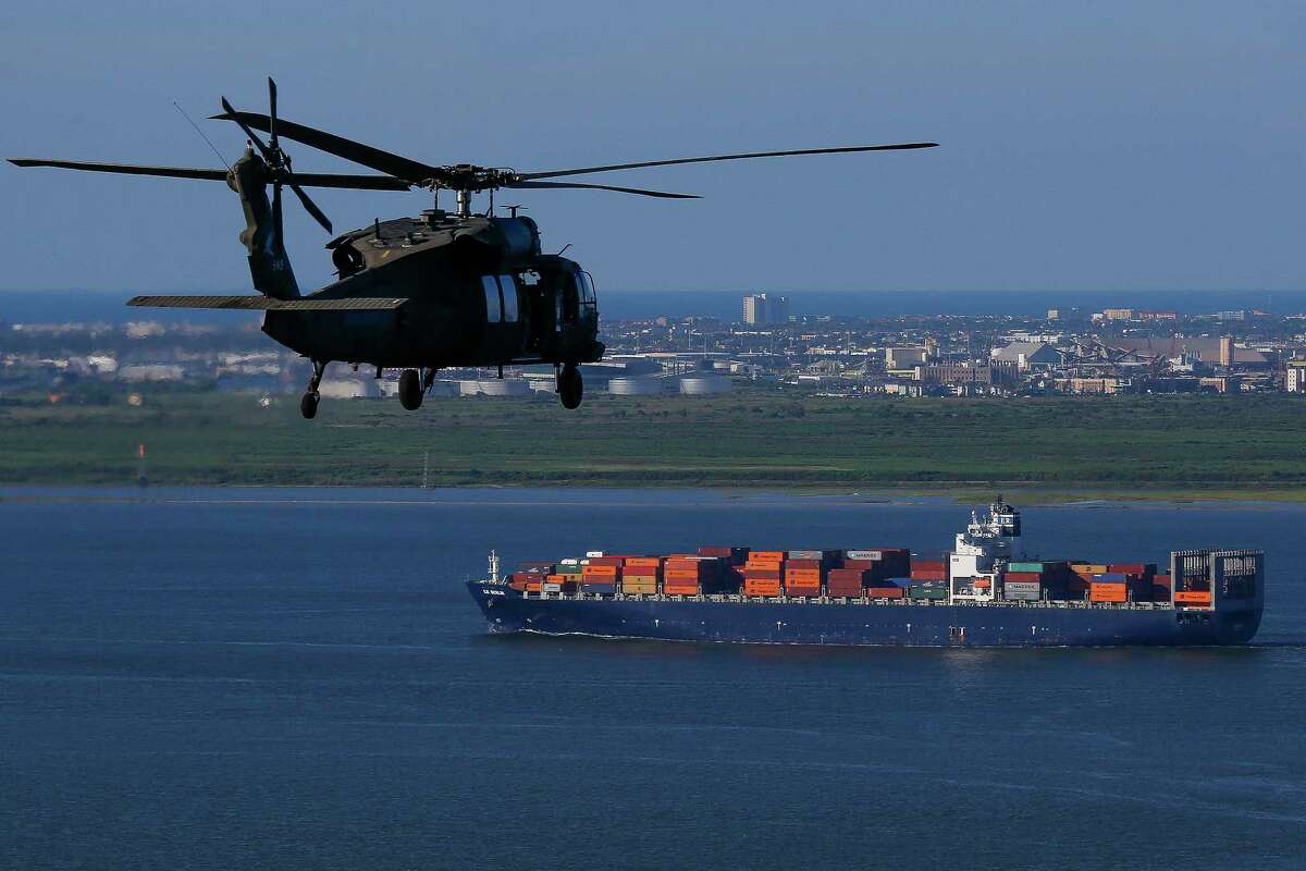 An Army Black Hawk helicopter, carrying Army Corps of Engineers officials in 2016, flies over the Houston Ship Channel. A dike, also known as the "coastal spine," is being proposed to protect Galveston, Bolivar and the Galveston Bay area from storm surges. ﻿