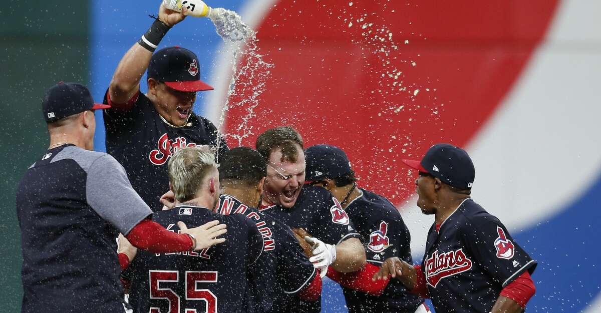 CLEVELAND, OH - SEPTEMBER 14: Jay Bruce #32 of the Cleveland Indians celebrates with teammates after hitting a game winning single off Brandon Maurer #32 of the Kansas City Royals during the tenth inning at Progressive Field on September 14, 2017 in Cleveland, Ohio. The Indians defeated the Royals 3-2 for their 22nd win in a row, an MLB record. (Photo by Ron Schwane/Getty Images)