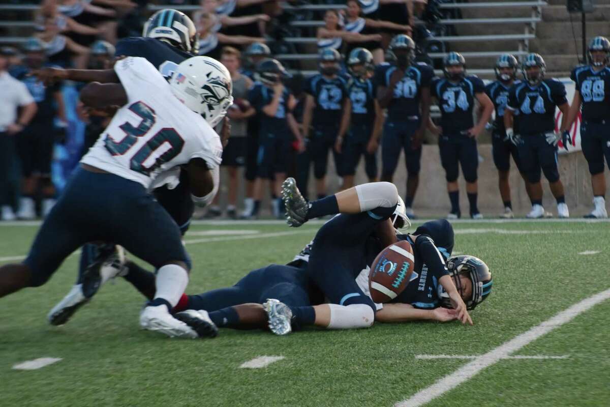 Clements' John Perry (4) fumbles the ball after being hit hard by Clear Lake's Sevon Roberson (10) Thursday, Sep. 14 at Fort Bend ISD Mercer Stadium.
