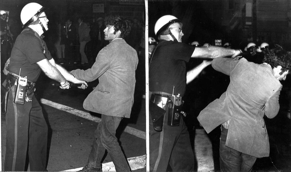 Police are using Mace to move anti-war demonstrators who are blocking access to the Oakland Induction Center, October 17, 1967 Draft and Vietnam War protesters Associated Press photo Photo ran 10/18/1967, p. 10