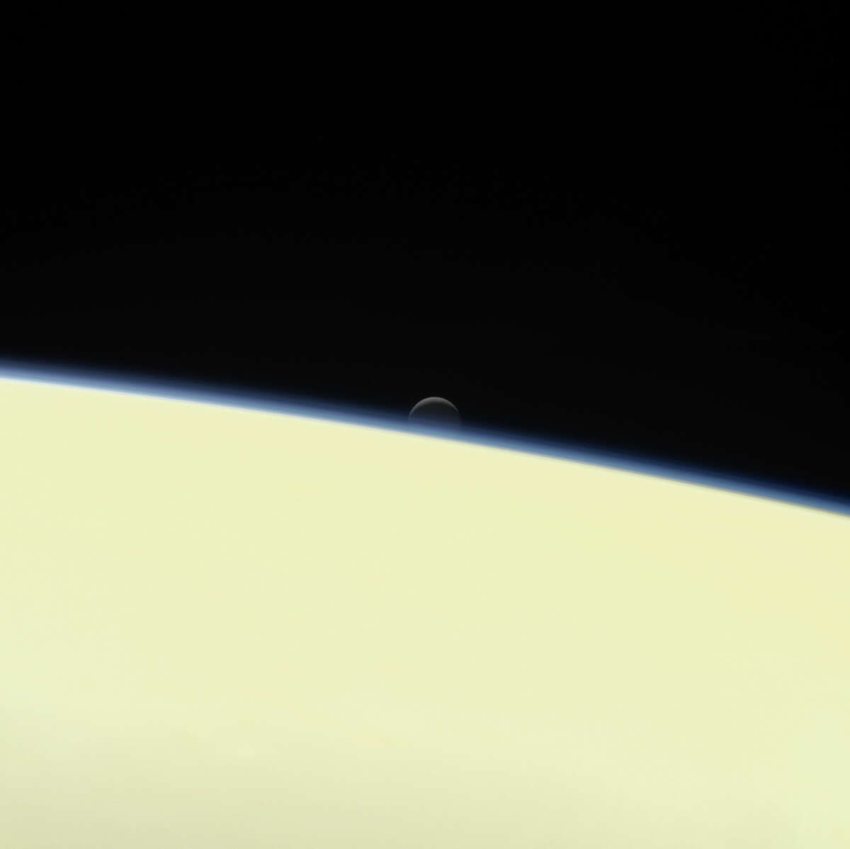 This image shows the moon Enceladus and the edge of Saturn as seen from the Cassini spacecraft on its descent toward the planet Wednesday.﻿