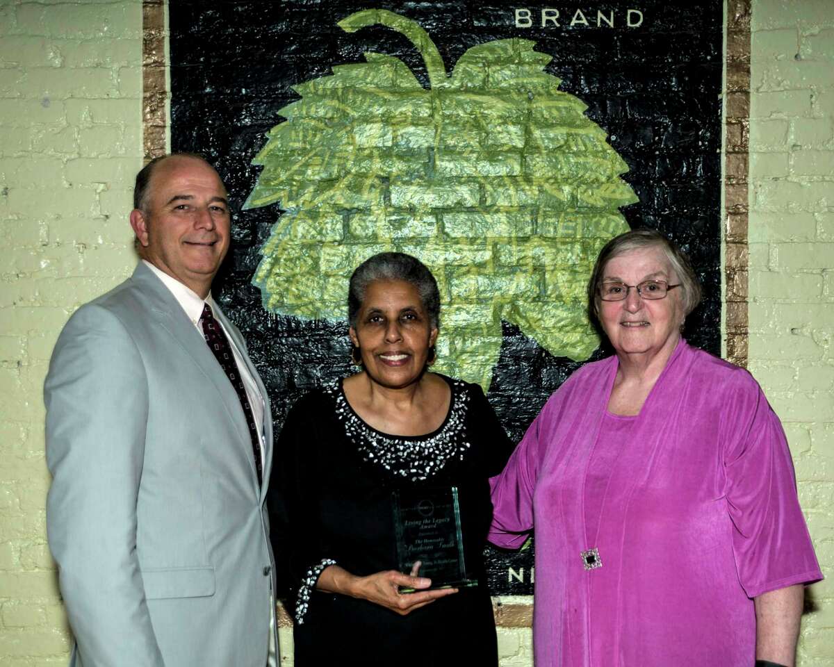 Former Albany City Councilwoman Barbara Smith, center, was the recipient of the Living the Legacy Award for her work as a pioneer in the fight for women?s rights and health since the 1960s at the Whitney Young Health annual fundraiser Thursday at Revolution Hall in Troy. Smith continues to work on numerous publications about the subject. In her role as the special community projects coordinator for the city of Albany, she helps to implement the Equity Agenda. She is seen here with Whitney Young Health President and CEO David Shippee, and Sister Gail Waring, Whitney Young Health board chairperson.