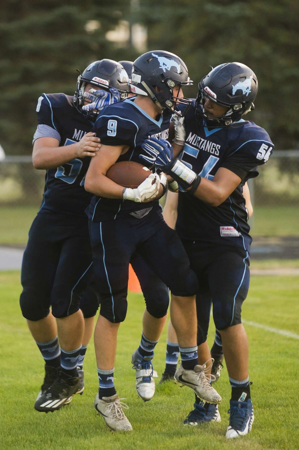 Meridian players celebrate a touchdown by sophomore Brady Solano, center, during Meridian's game against Roscommon on Friday, September 15, 2017 at Meridian Early College High School. (Katy Kildee/kkildee@mdn.net)