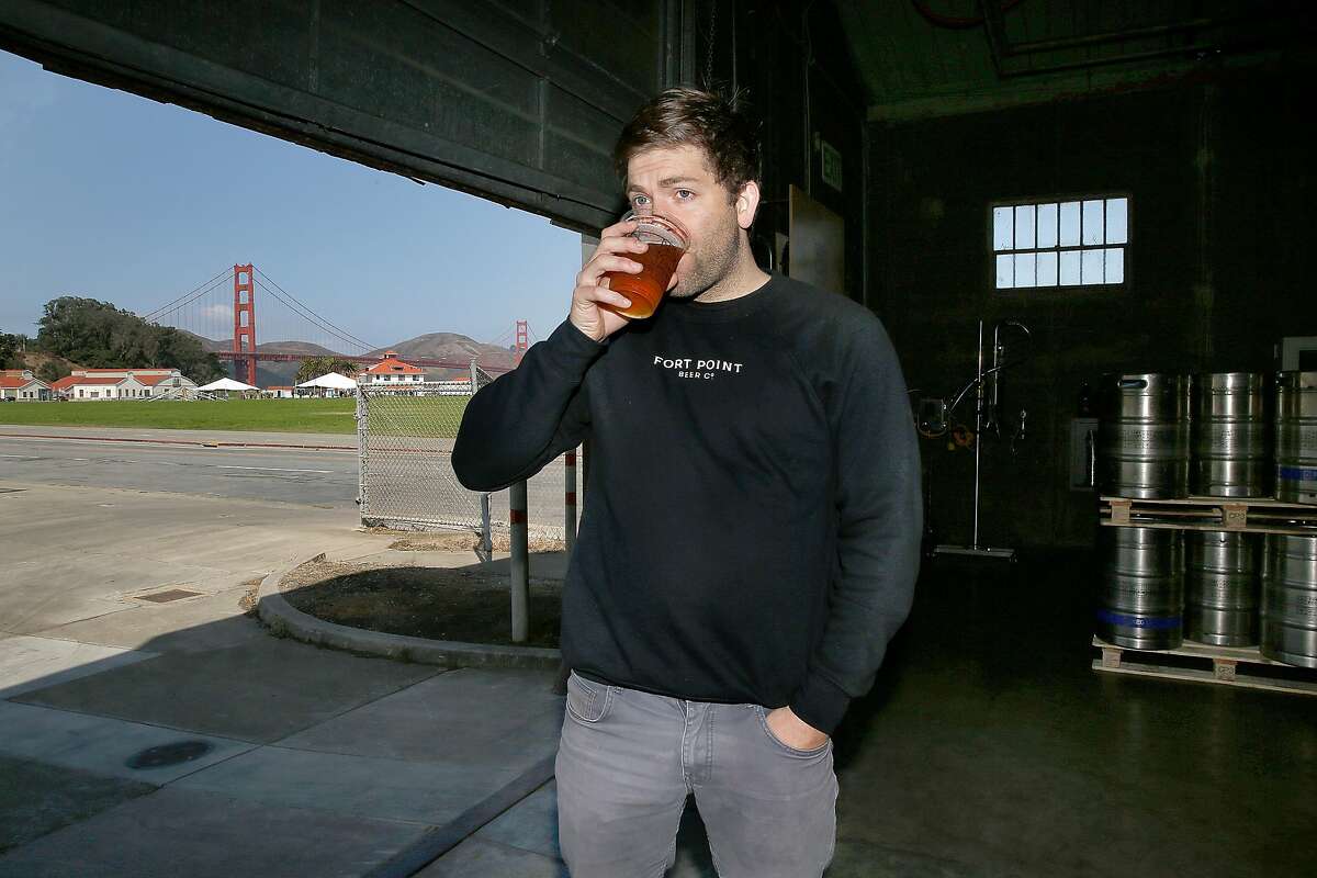 Fort Point brewery co-founder Justin Catalana has a beer in his brewery at the Presidio on Friday, September 15, 2017, in Mill Valley, Calif.