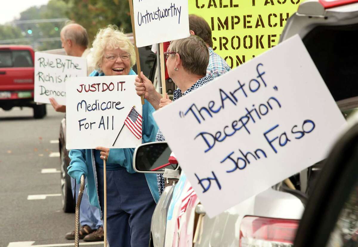 People participate in a ?’Faso Friday?“ protest event outside U.S. Rep. John Faso?•s office on Friday, Sept. 15, 2017 in Kingston, N.Y. (Lori Van Buren / Times Union)