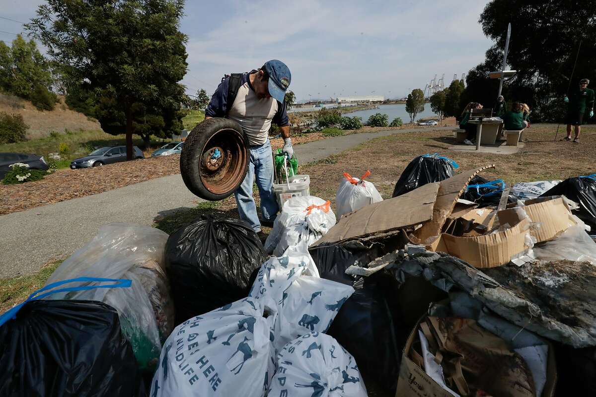 Eric Hoover found a tire and places it into the pile collected at India Basin Shoreline Park on Saturday, Sept. 16, 2017 in San Francisco, CA.