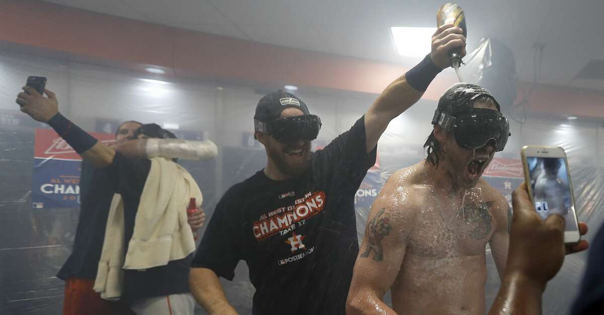 Houston Astros Josh Reddick screams as Derek Fisher pours champagne on him as they celebrated after after clinching the American League West crown after beating the Seattle Mariners 7-1 during an MLB baseball game at Minute Maid Park, Sunday, Sept. 17, 2017, in Houston. ( Karen Warren / Houston Chronicle )