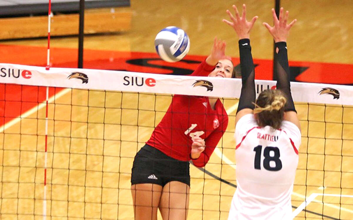 SIUE’s Emily Harrison, left, goes for a kill during Saturday’s match against Montana in the SIUE Invite.