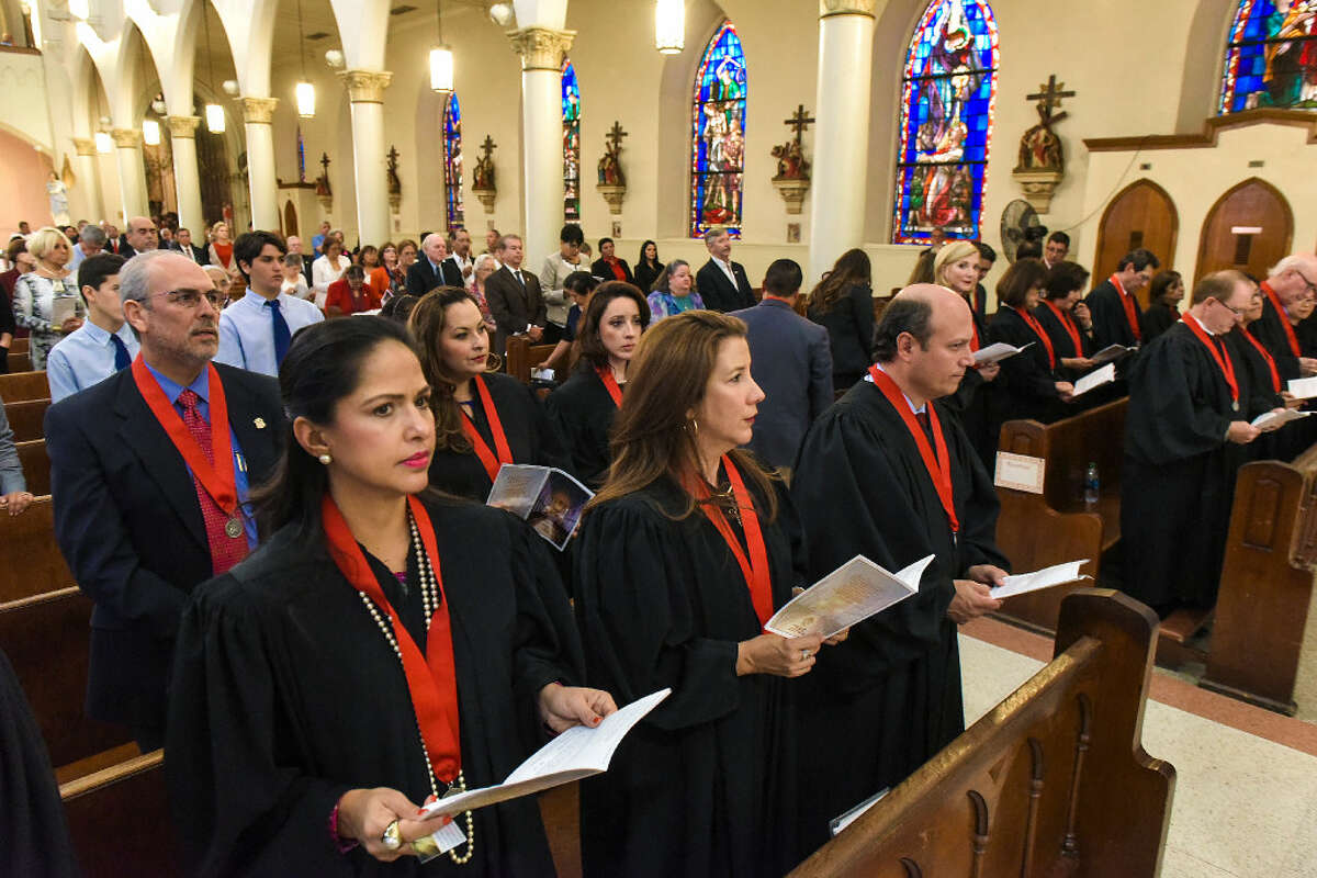 Judges Becky Palomo, Monica Notzon and Oscar J. Hale Jr., along with other judges, attorneys and government officials, participate in a Red Mass at San Agustin Cathedral on Tuesday evening.