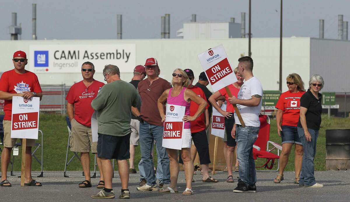 Employees of the General Motors CAMI Assembly factory stand on the picket line in Ingersoll, Ontario, Canada, Monday, Sept. 18, 2017. The 2,500 members of Unifor local 88 walked out Sunday at 10:59 p.m. when negotiators for the union and the automaker failed to come to terms on a new contract agreement. (Dave Chidley/The Canadian Press via AP)