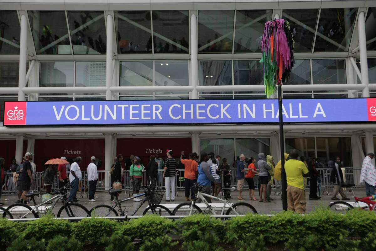 Evacuees line up outside the George R. Brown Convention Center in Houston on Aug. 29 because of the record rainfall and flooding caused by Hurricane Harvey. (Elizabeth Conley / Houston Chronicle )
