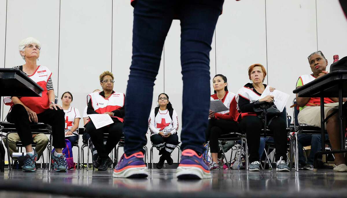 Red Cross manager Sue Engler instructs volunteers at the George R. Brown Convention Center on Sunday, Sept. 10, 2017, in Houston. ( Elizabeth Conley / Houston Chronicle )