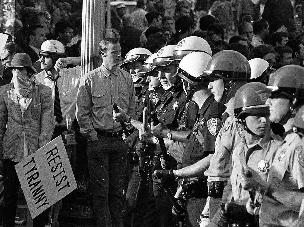Anti-War protesters march against the Vietnam War and the draft at the Oakland Induction Center, October 20, 1967