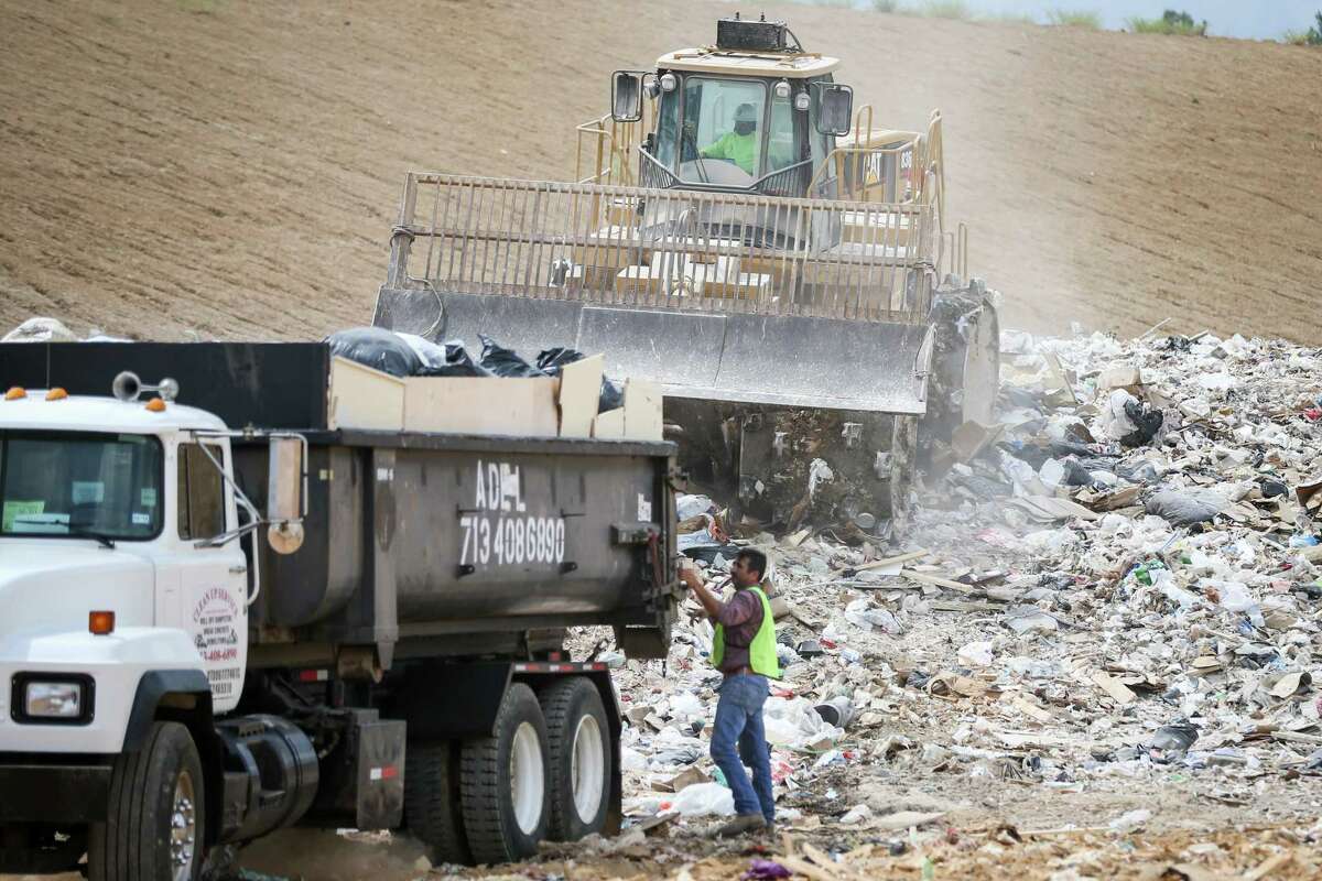 Employees of Sprint Waste Services unload and compact trash on Monday, Sept. 18, 2017, at the Sprint Montgomery County Landfill.