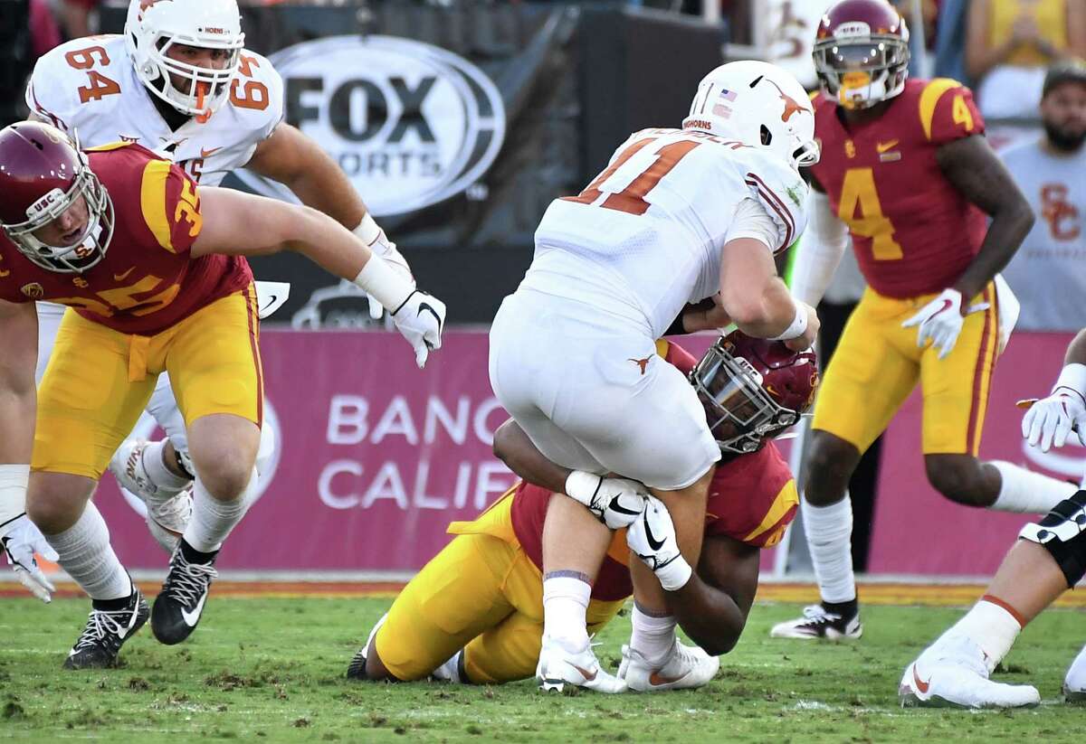 Southern Cal linebacker Uchenna Nwvosu stops Texas quarterback Sam Ehlinger on fourth down in the first quarter, part of a dismal rushing performance by the Longhorns on Saturday night.