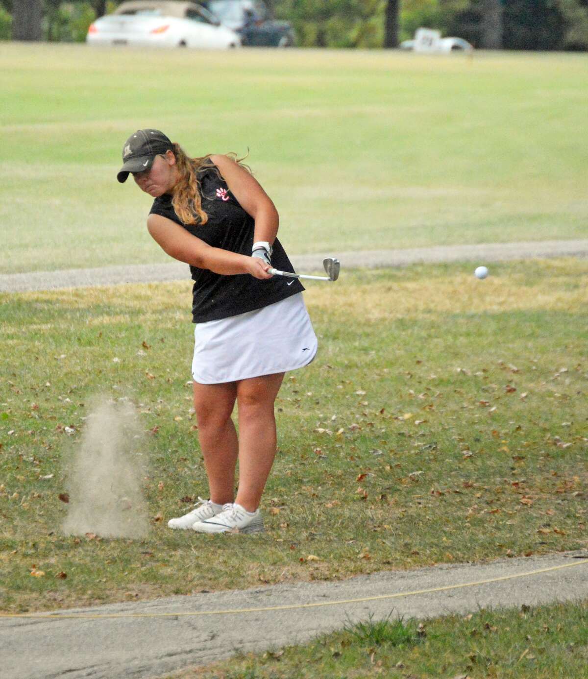 Edwardsville’s Carlie Van Patten hits her shot on to the green.