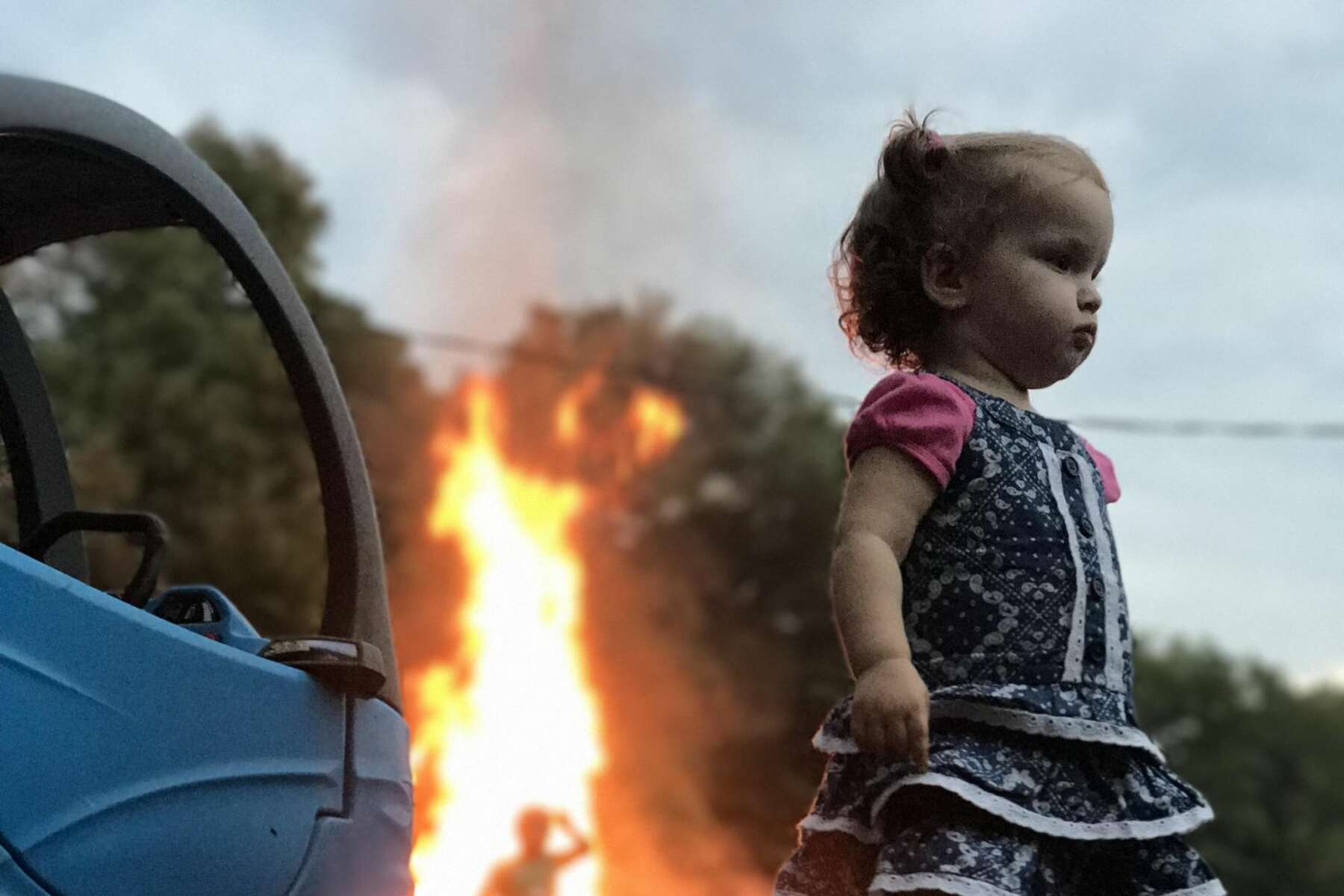 Photo Of Girl Standing Stoically By Fire Is The Latest And Greatest Internet Meme