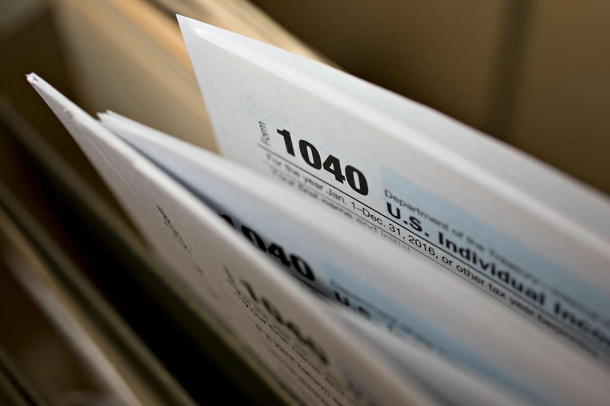U.S. Department of the Treasury Internal Revenue Service (IRS) 1040 Individual Income Tax forms for the 2016 tax year are arranged for a photograph in Tiskilwa, Illinois, U.S., on Tuesday, March 28, 2017. Due to the Emancipation day holiday, this year's income taxes will need to be filed by April 18 instead of April 15. Photographer: Daniel Acker/Bloomberg