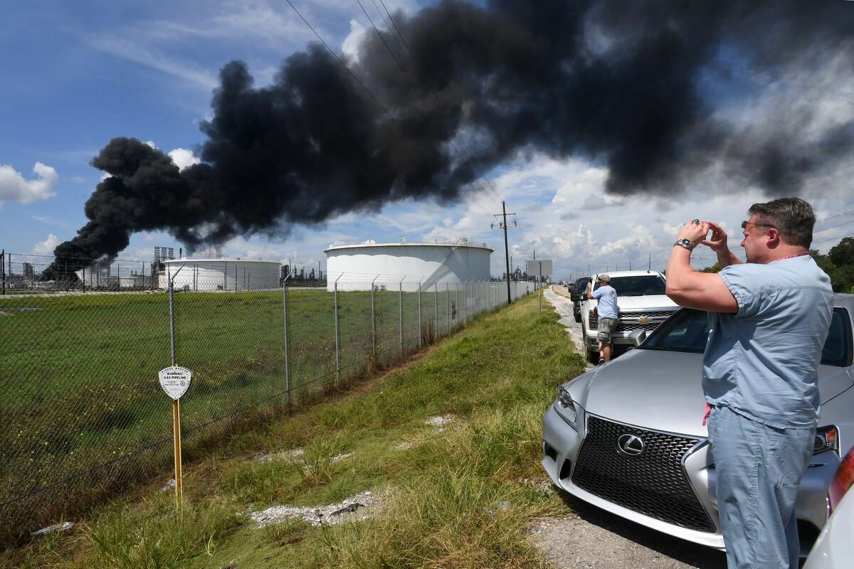 Black smoke rises from a storage tanker at the Valero facility in Port Arthur, Texas on Friday. Several onlookers stop to photograph the site. Photo taken Wednesday, September 19, 20187 Guiseppe Barranco/The Enterprise