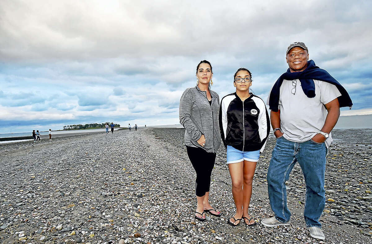 Renee and Joseph Williams and their 12-year-old daughter Nya, of New York, visit Silver Sands State Park, a public recreation area located on Long Island Sound in Milford, Tuesday, July 25, 2017. (Catherine Avalone – Hearst Connecticut Media)
