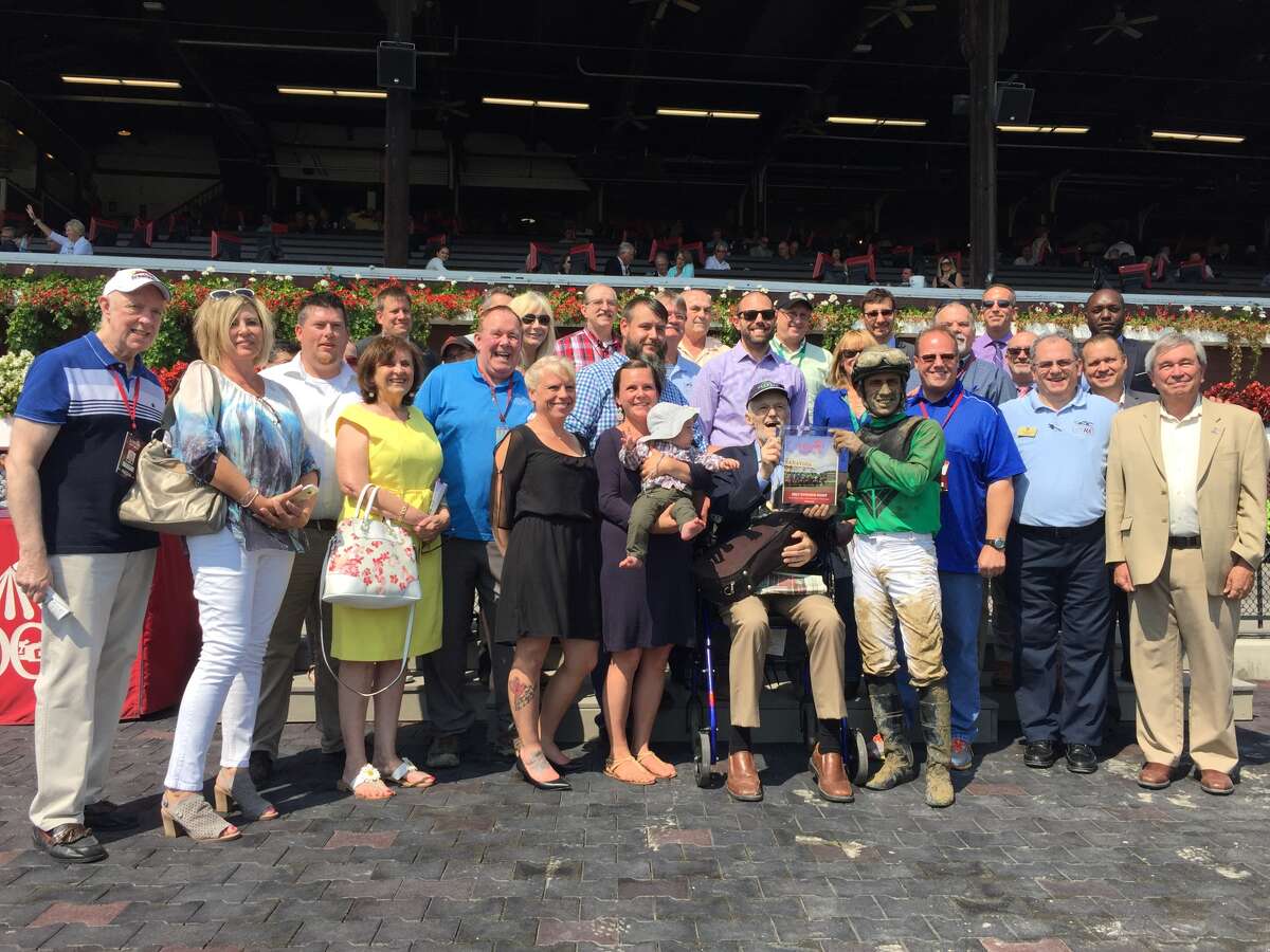Times Union's Mike Jarboe, a horse racing handicapper for the newspaper, is surrounded by friends and family in the winner's circle after a race named in his honor at Saratoga Race Course on September 4, 2017. (Joyce Bassett / Times Union)