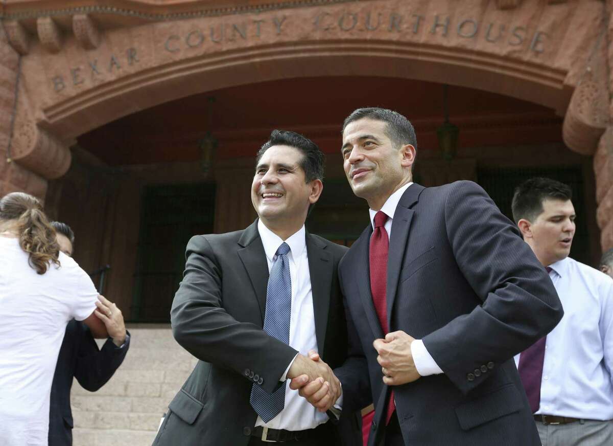 Manuel Medina, left, shakes hands Tuesday, Sept. 19, 2017 outside the Bexar County Courthouse with Bexar County District Attorney Nicholas "Nico" LaHood after LaHood announced his re-election bid.