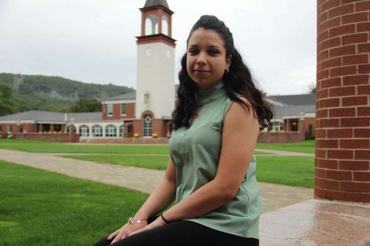 Quinnipiac University senior Shelma Morales, of New Britain, sits outside the Carl Hansen Student Center on Tuesday, Sept. 19, in Hamden. Morales, who majors in biomedical sciences, is from Puerto Rico and was one of several students whose families face possible impact from Hurricane Maria.