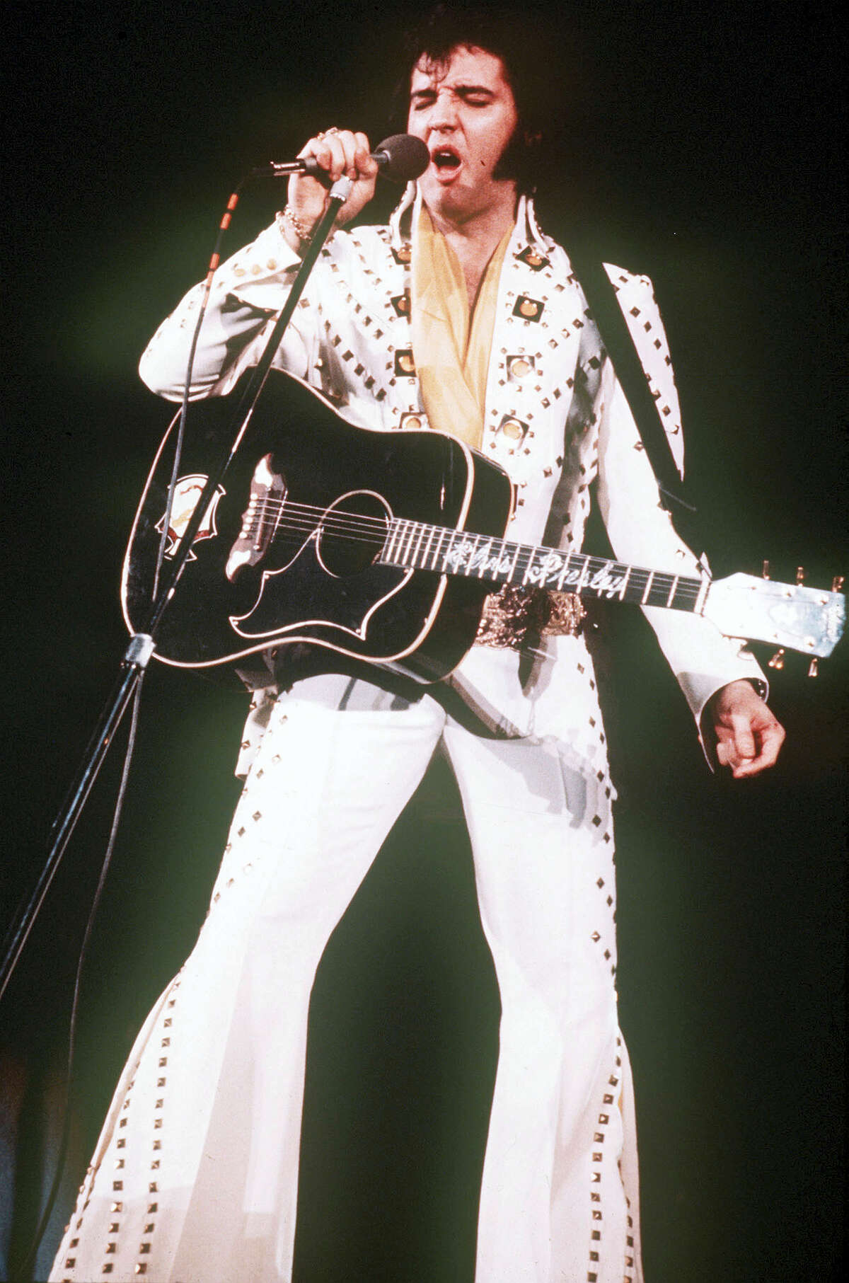 In this 1973 file photo, Elvis Presley sings during a concert. Friends and fans of late singer and actor Elvis Presley are descending on Memphis, Tenn., for Elvis Week, the annual celebration of his life and career. It coincides with the 40th anniversary of the passing of Presley, who died on Aug. 16, 1977.