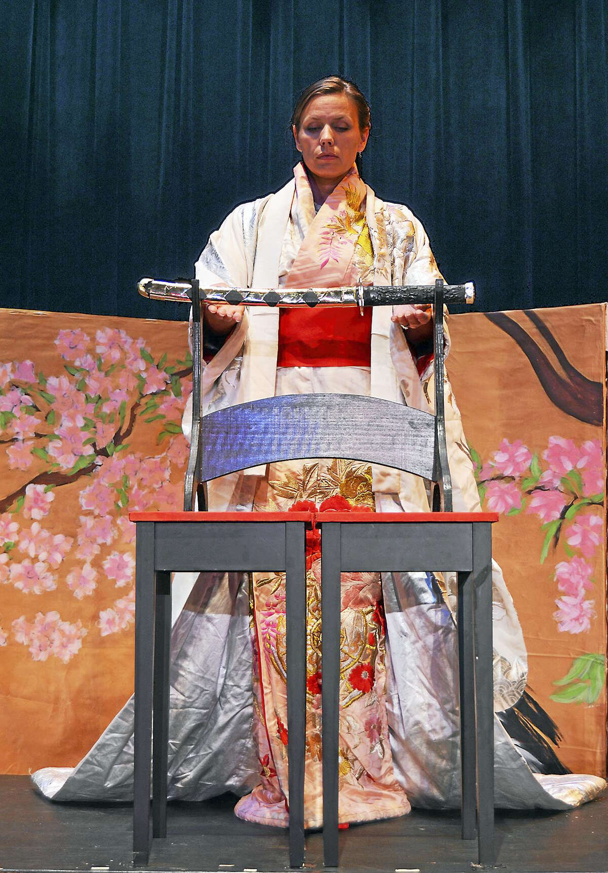 Shannon Kessler Dooley (Madama Butterfly) in formal wedding garb with a katana (samurai sword) in Opera Theater of Connecticut’s “Madama Butterfly.”