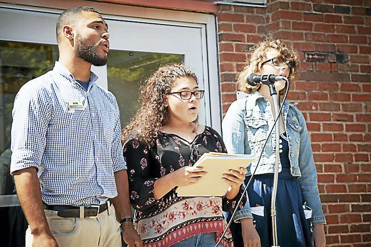 Middlesex Community College students Daniel Ortiz, Gilianne Oyolo and Marina Capezzone sang “This Land is Your Land” at the school’s recent CommUNITY event.