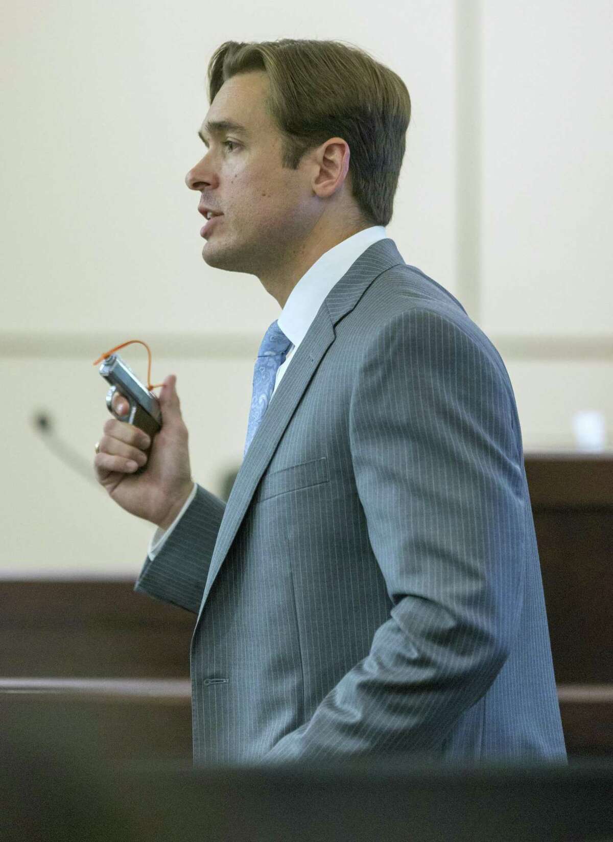 Assistant district attorney Josh Somers holds the .25 caliber pistol Tuesday, Sept. 19, 2017 used to kill Xavier Cordero, Jr. and Steven Rendon as he makes his closing argument in Antoinette Martinez's capital murder trial. The jury found Martinez guilty on both counts of capital murder and she was automatically sentenced to life without parole since the prosecutors did not seek the death penalty.