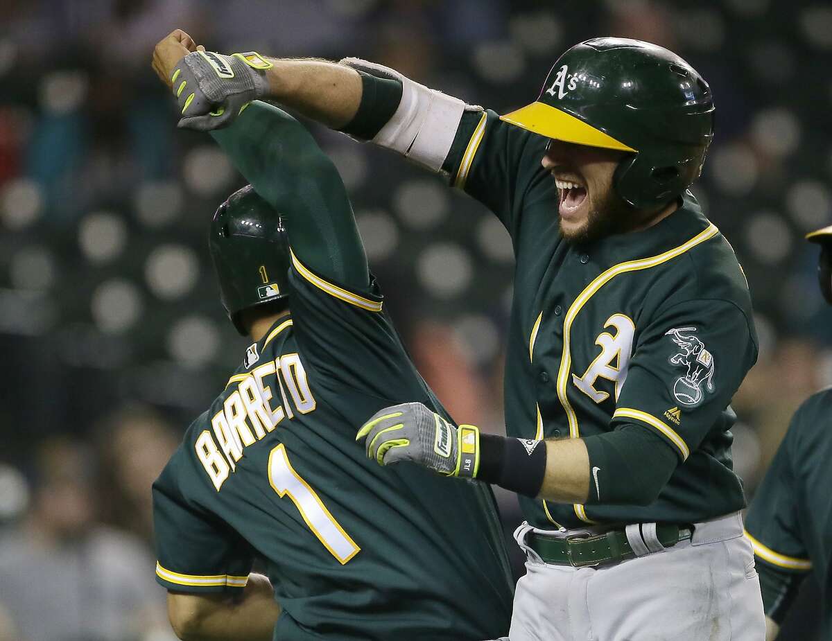 DETROIT, MI - SEPTEMBER 19: Jed Lowrie #8 of the Oakland Athletics celebrates with Franklin Barreto #1 of the Oakland Athletics after hitting a grand slam to take a 9-8 lead over the Detroit Tigers during the eighth inning at Comerica Park on September 19, 2017 in Detroit, Michigan. (Photo by Duane Burleson/Getty Images)
