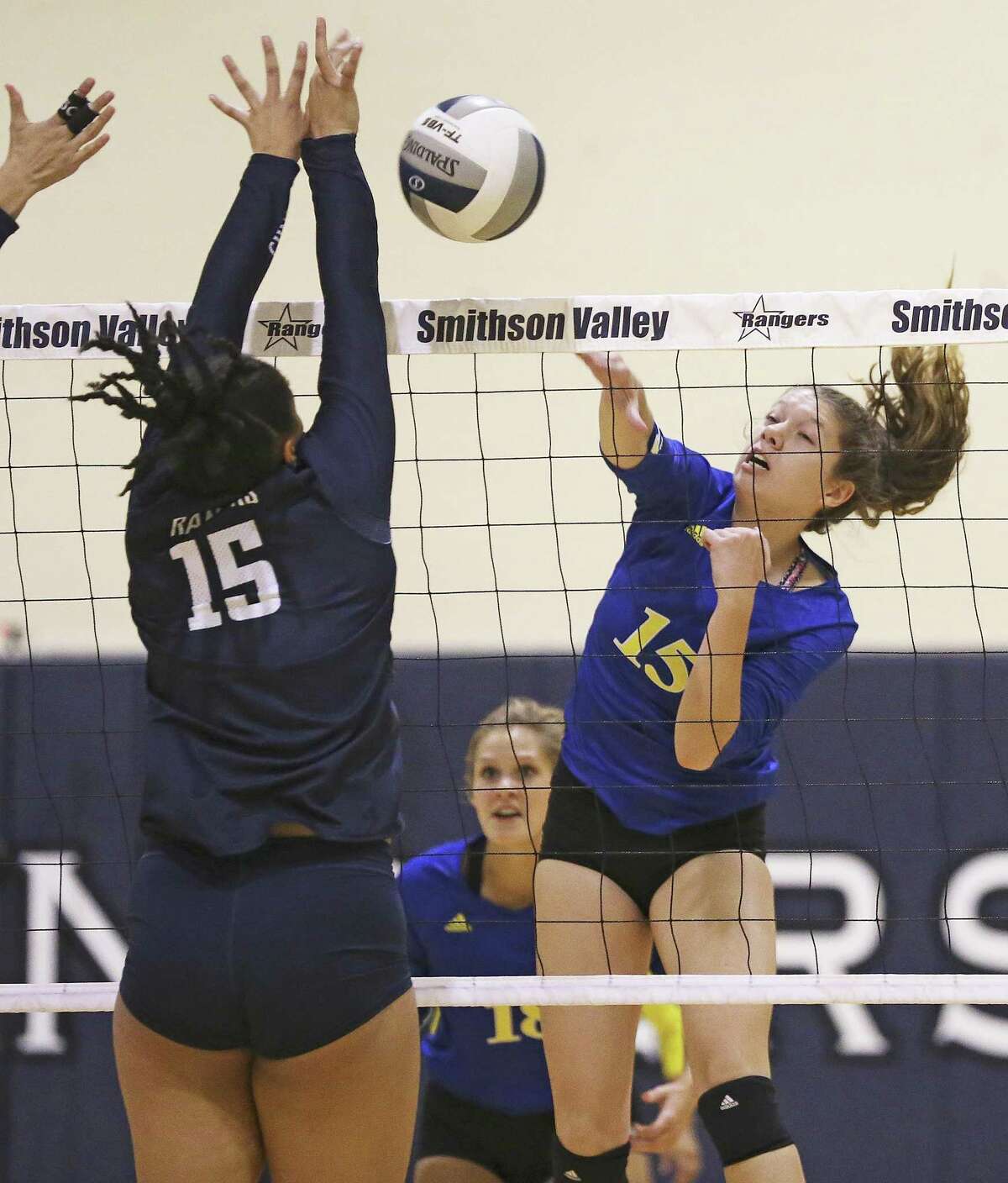 Shelby O'Neal gets a shot for Clemens to go past the Ranger's Tanyse Moehrig as Smithson Valley hosts Clemens in volleyball on September 19, 2017.