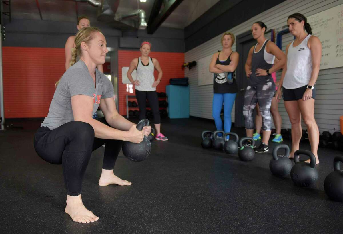 Instructor Stephanie Kosnick demonstrates a move during a kettlebell class at Founder's HIIT and Strength Club on Wednesday, Aug. 23, 2017, in Delmar, N.Y. (Paul Buckowski / Times Union)