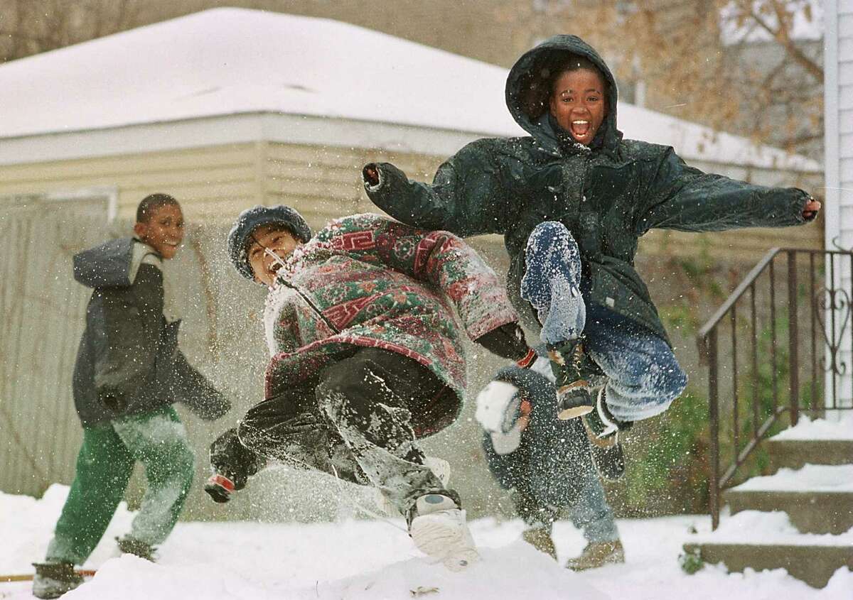 FRIDAY, NOV. 14, 1997 -- Ashley Galloway, 10, and Moneeka Fallen, 11, enjoy the area's first snowstorm of the season on Third Street in Albany. (TIMES UNION PHOTO BY LUANNE M. FERRIS)