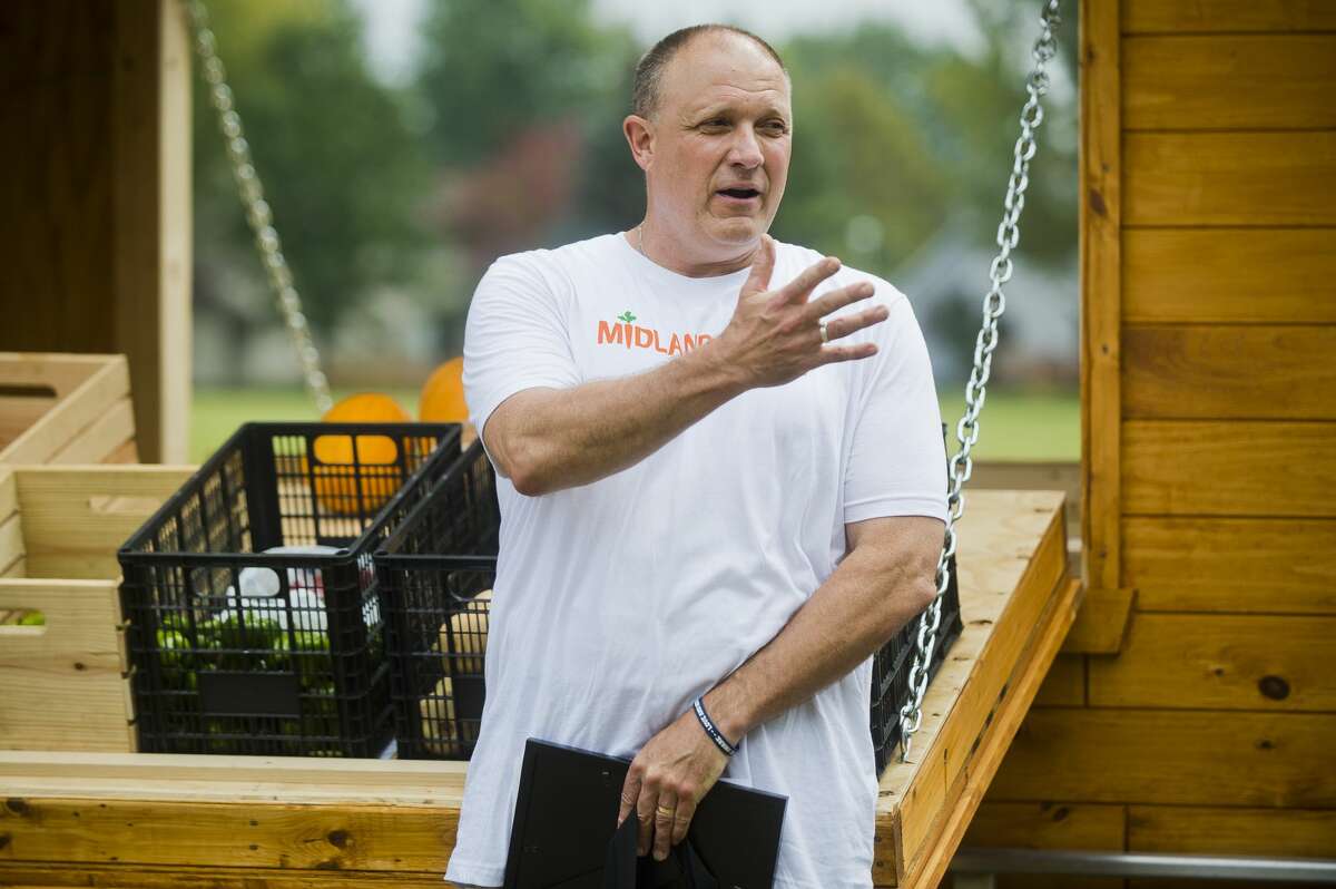 Kurt Faust, who spearheaded the Midland Fresh project, speaks during a ribbon cutting for the mobile farm stand on Wednesday at Midland Nazarene. (Katy Kildee/kkildee@mdn.net)