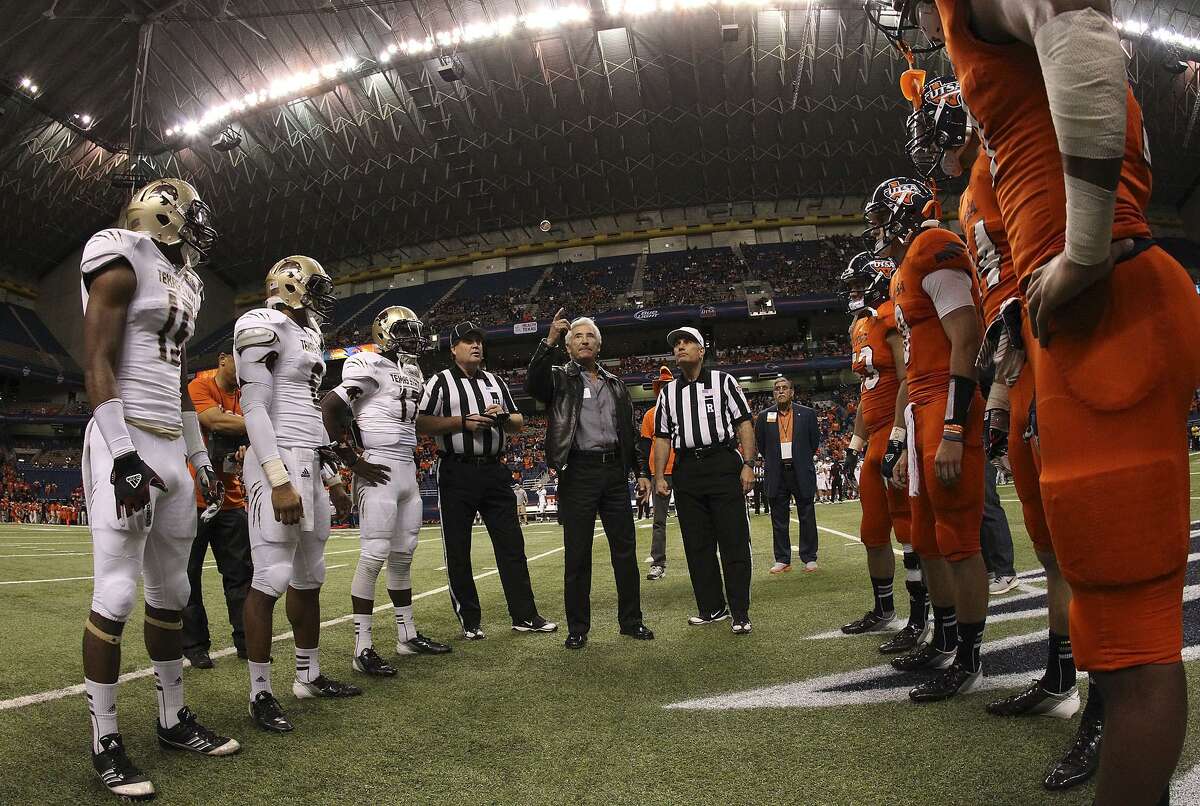 UTSA and Texas State players gather for the pregame coin toss with local businessman Ernesto Ancira before the game at the Alamodome on Nov. 24, 2012.