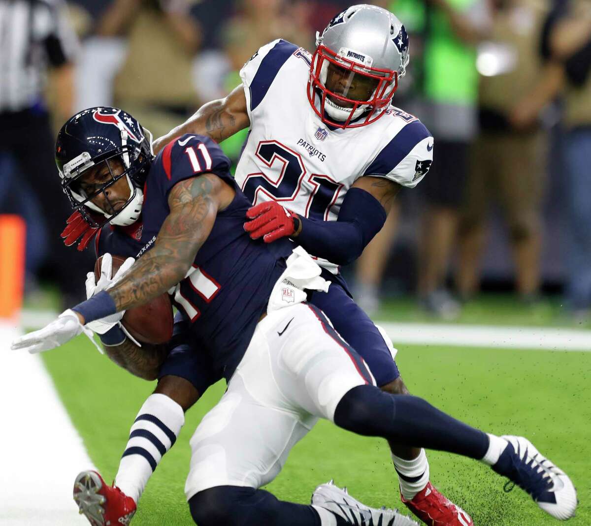 Houston Texans wide receiver Jaelen Strong (11) comes down with a 2-yard touchdown reception against New England Patriots cornerback Malcolm Butler (21) during the first quarter of an NFL preseason game at NRG Stadium, Saturday, Aug. 19, 2017, in Houston. ( Karen Warren / Houston Chronicle )