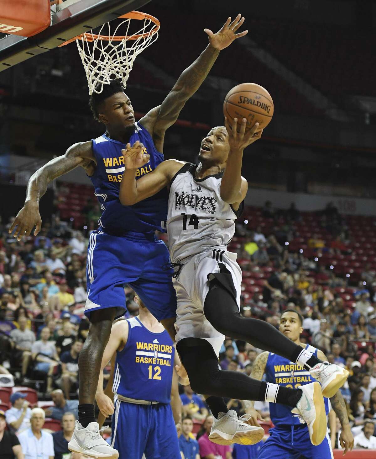 Above: LAS VEGAS, NV - JULY 12: C.J. Williams #14 of the Minnesota Timberwolves drives to the basket against Jordan Bell #2 of the Golden State Warriors during the 2017 Summer League at the Thomas & Mack Center on July 12, 2017 in Las Vegas, Nevada. Golden State won 77-69. NOTE TO USER: User expressly acknowledges and agrees that, by downloading and or using this photograph, User is consenting to the terms and conditions of the Getty Images License Agreement. (Photo by Ethan Miller/Getty Images)
