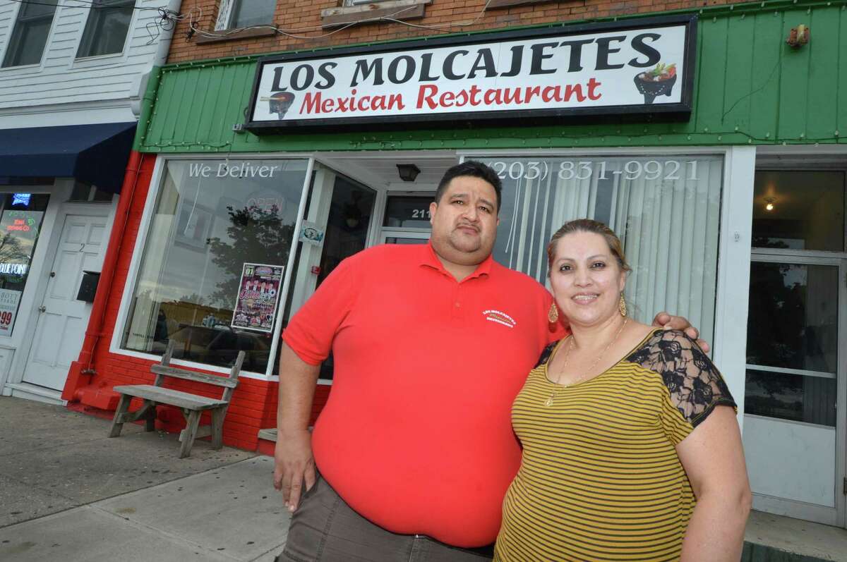 Carlos and Griselda Vargas stand in front of the restaurant they own, Los Molcajetes Mexican Restaurant, in Liberty Square in Norwalk in 2017. 