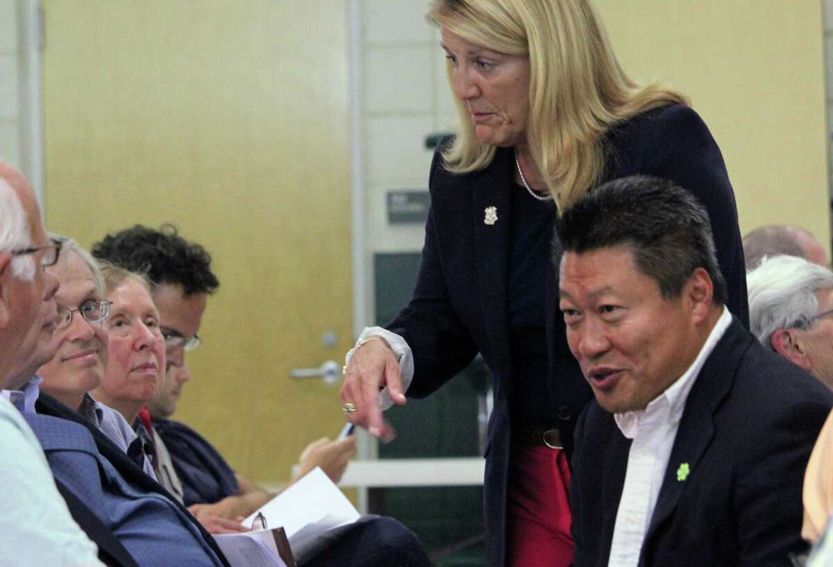 State Rep. Brenda Kupchick, R-132, and state Sen. Tony Hwang R-28, talk with residents before the start of a forum on affordable housing Monday. Fairfield,CT. 9/20/17